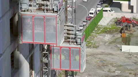 Freight elevator at the construction site of a tall building rides up and down Stock Footage 172521795