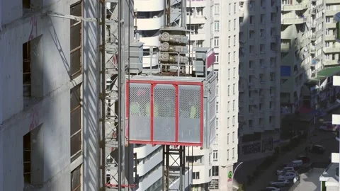 Freight elevator at the construction site of a tall building rides up and down Stock Footage 172521824
