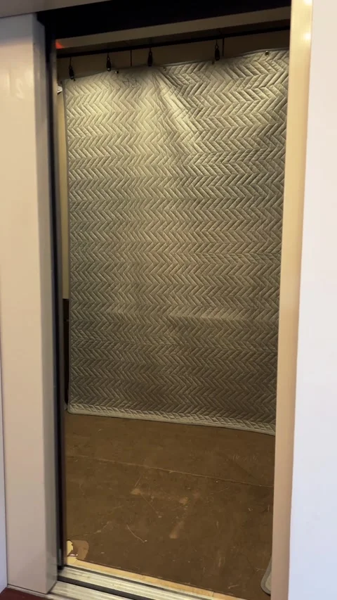 Freight moving elevator with protection pads door opening and closing Stock Footage 278119014