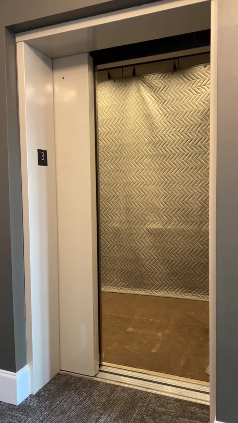 Freight moving elevator with protection pads door opening and closing Stock Footage 278119051