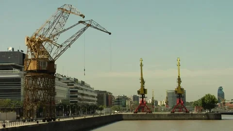 Freight ship cranes in the harbour of Buenos Aires with city buildings Stock Footage 160280630