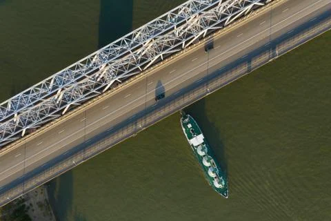A freight ship has just passed the bridge. Stock Photos