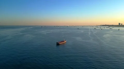 Freight ship navigating vast ocean with many vessels. Nice aerial view drone Stock Footage 344613155