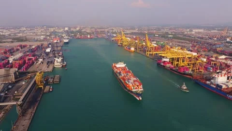 Freight ship sailing away from harbor, Thailand Stock Footage 303497975