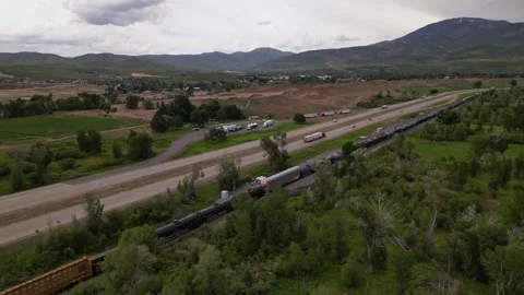 Freight train and highway road mountain on background Stock Footage 248123246