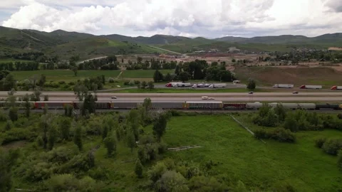Freight train and highway road mountain on background Stock Footage 248123247