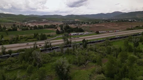 Freight train and highway road mountain on background Stock Footage 248123255