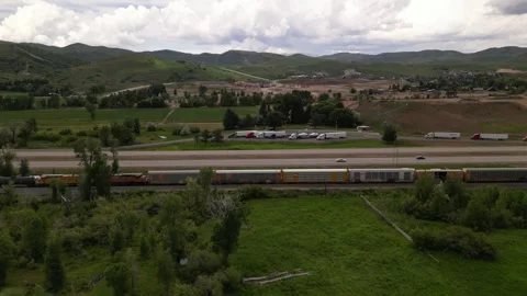 Freight train and highway road mountain on background Stock Footage 248123258