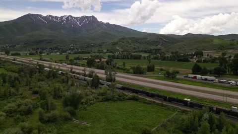 Freight train and highway road mountain on background Stock Footage 248123271