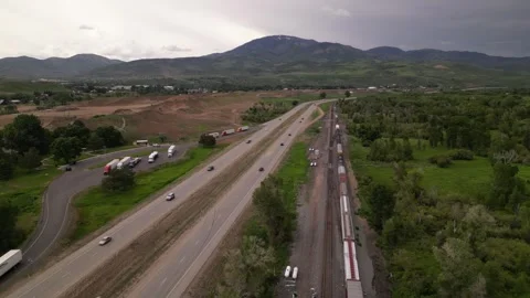 Freight train and highway road mountain on background Stock Footage 248123274
