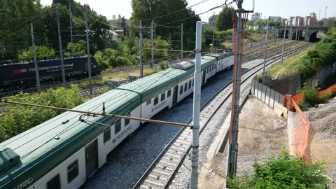 Freight train and passenger train run side by side towards the tunnel Stock Footage 162184594
