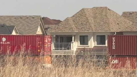 Freight train and shipping containers in residential area with homes close by Vídeos de archivo 151666981