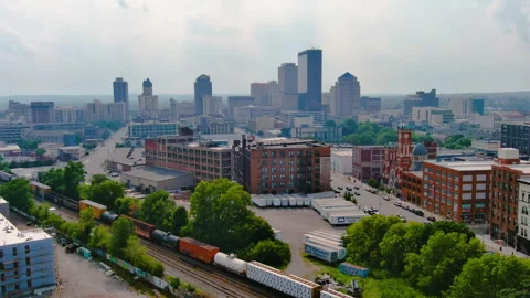 Freight Train and Warehouses in front of City Skyline Drone Shot 4K Stock Footage 246943597