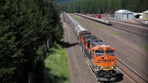 Freight train approaches and passes under Video stock 90538283