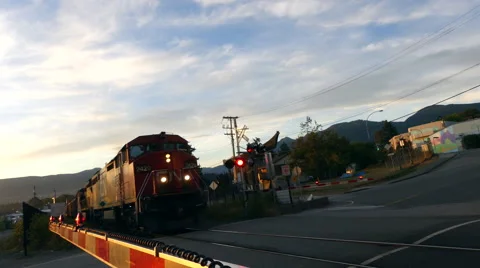 Freight train approaching crossing Stock Footage