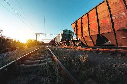 Freight train in the background of sunset - dawn is waiting for departure to  Stock Photos
