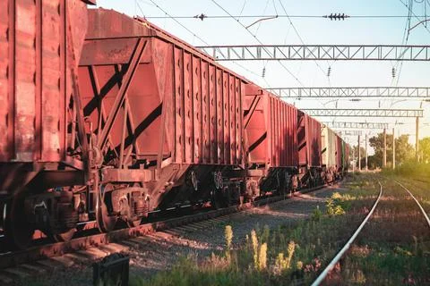 Freight train in the background of sunset - dawn is waiting for departure to  Stock Photos