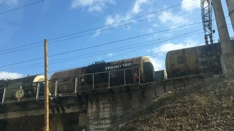 Freight train with barrels on the bridge Stock Footage 127315843