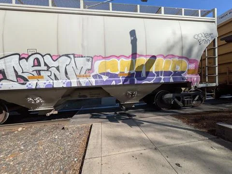 Freight train car covered in colorful graffiti artwork Stock Photos