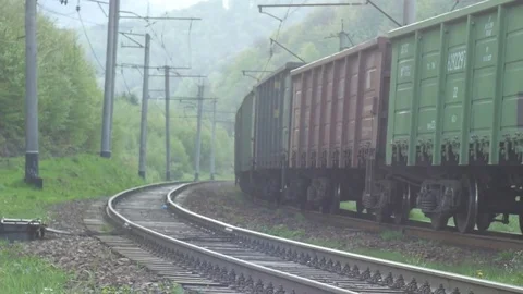 Freight train with cargo containers passing. Railway wagons Ukraine, Carpathians Video stock 75491035