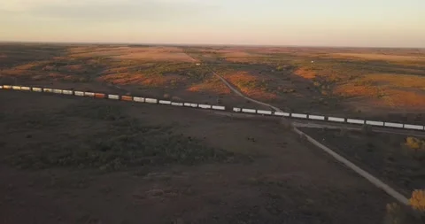 Freight Train with Cargo Driving through a Scenic, plain Countryside USA Vídeo Stock 135872313