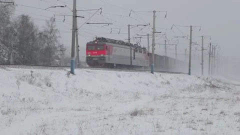 Freight train with carriages on railways at winter Video stock 100030240