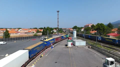 Freight Train Carrying Containers Passing Through Rail Yard Near Residential Stock Footage 337601277