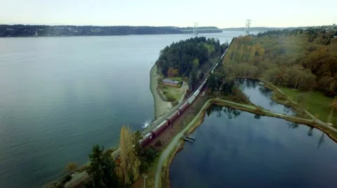 Freight train carrying containers in urban city area by a coast Stock-Footage 49644979