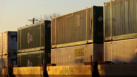 Freight train carrying shipping containers at sunset Stock Footage 340486433
