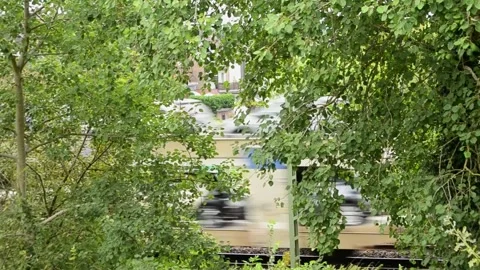 A freight train with cars going fast behind the trees Stock Footage 281107790