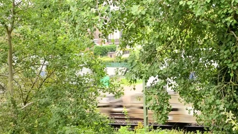A freight train with cars going fast behind the trees Stock Footage 281107817