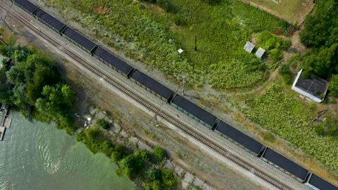 Freight train with coal in the woods on the lake, nature of Urals, transport Stock Footage 165343699