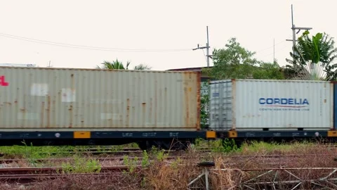 Freight train containers transporting goods railway yard industrial scene Stock Footage 336365644