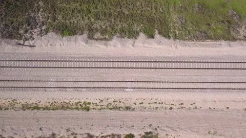 Freight Train crossing the frame In high speed, Top down aerial view. Stock Footage 130917701