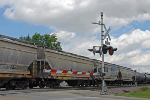 Freight train at crossing gate Stock Photos