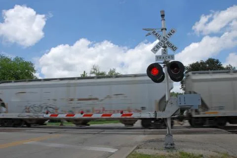 Freight train at crossing gate Stock Photos