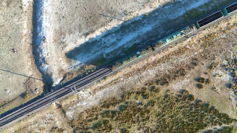 Freight train crossing over rails aerial  At sunset and shadows locomotive Stock Footage 284771191