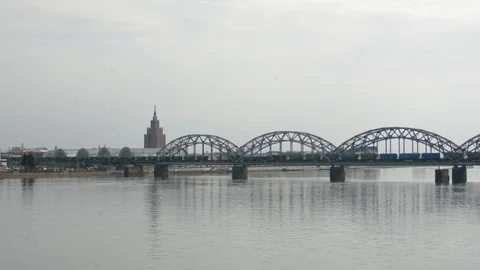 Freight train crossing railway bridge and entering the city of Riga 스톡 동영상 89238513