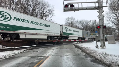 Freight train at crossing in winter Stock Footage 301922770