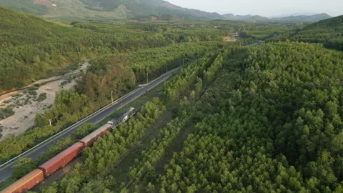 Freight Train Drives Behind Hill At Sunset Dak Lak Province Vietnam Drone Stock Footage 338416428