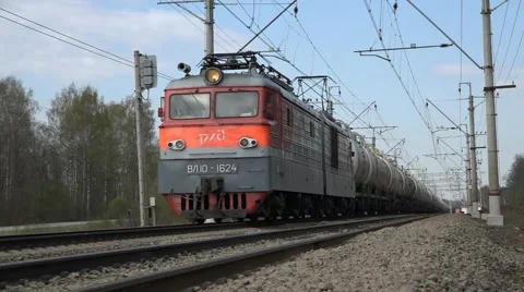 Freight train: electric engine hauls several dozens of tank cars Stock Footage 62796353
