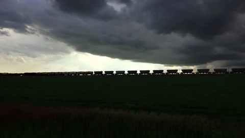Freight train in front of dark clouds Video stock 128641165