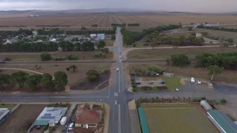 Freight train going through a crossing in a country town aerial 4k Stock Footage 282068982