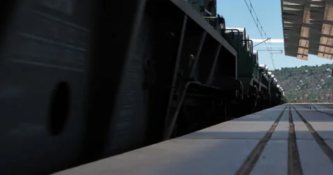 Freight train going through empty station at high speed without stopping Stock Footage 216540681