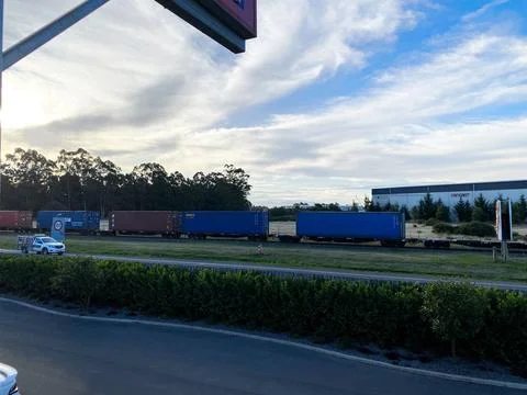 Freight train hauling assorted blue and red cargo shipping containers on ra.. Stock Photos