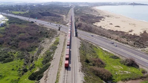 Freight Train hauling Shipping Containers on highway bridge, Aerial view. Stock Footage 124785084