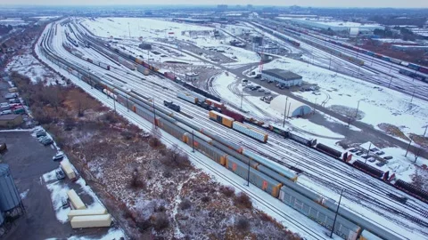 Freight train, laden with cargo along a railway in urban setting. Canadian .. Stock Footage 263685161
