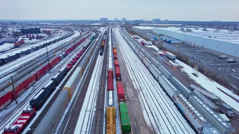 Freight train, laden with cargo along a railway in urban setting. Canadian .. Stock Footage 263685163