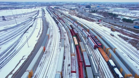 Freight train, laden with cargo along a railway in urban setting. Canadian .. Stock Footage 263685185