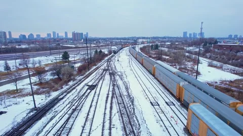 Freight train, laden with cargo along a railway in urban setting. Canadian .. Stock Footage 263685242